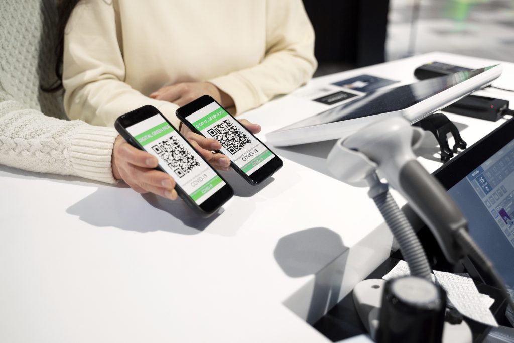 Two Cellphones With QR Code Payments Scanned Using A Barcode Scanner