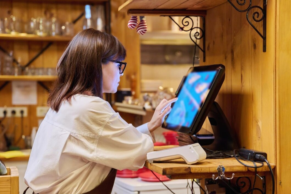 A woman using a POS system | Condor PH A woman using a POS system | Condor PH