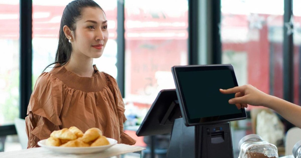 Woman wearing brown dress ordering in POS system
