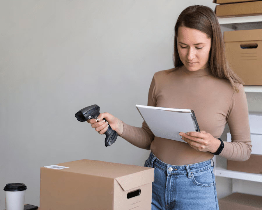 A Woman Reading A Manual While Holding A Barcode Scanner | Condor PH A Woman Reading A Manual While Holding A Barcode Scanner | Condor PH