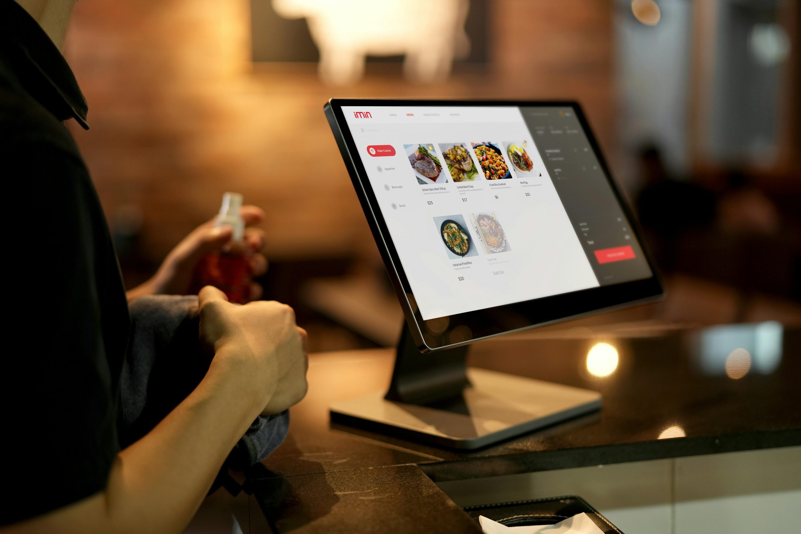 Restaurant Staff Operating a Touchscreen POS System with a Digital Menu Display | Condor PH Restaurant Staff Operating a Touchscreen POS System with a Digital Menu Display | Condor PH