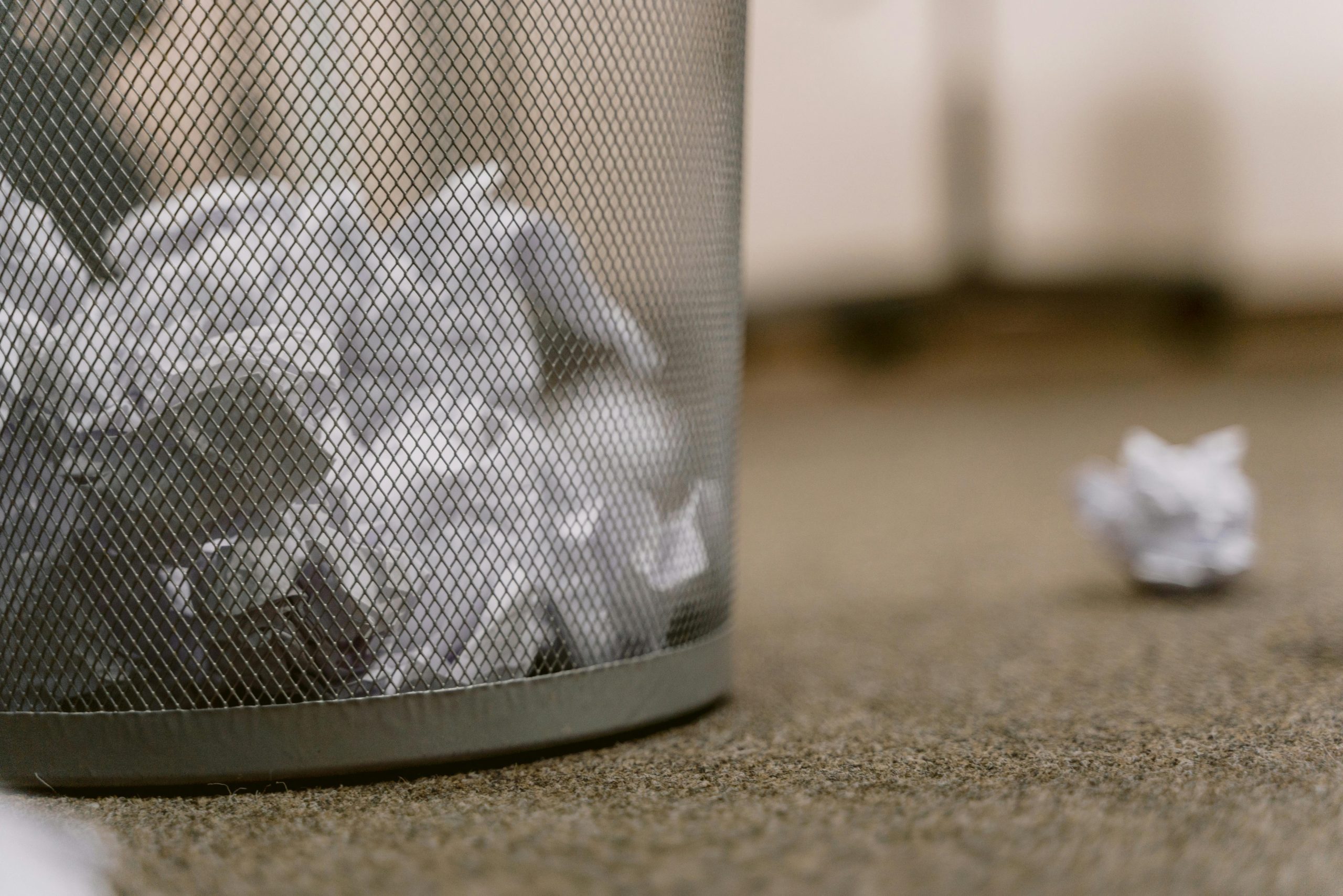 A Mesh Trash Bin Filled with Crumpled Paper Waste on an Office Floor | Condor PH A Mesh Trash Bin Filled with Crumpled Paper Waste on an Office Floor | Condor PH