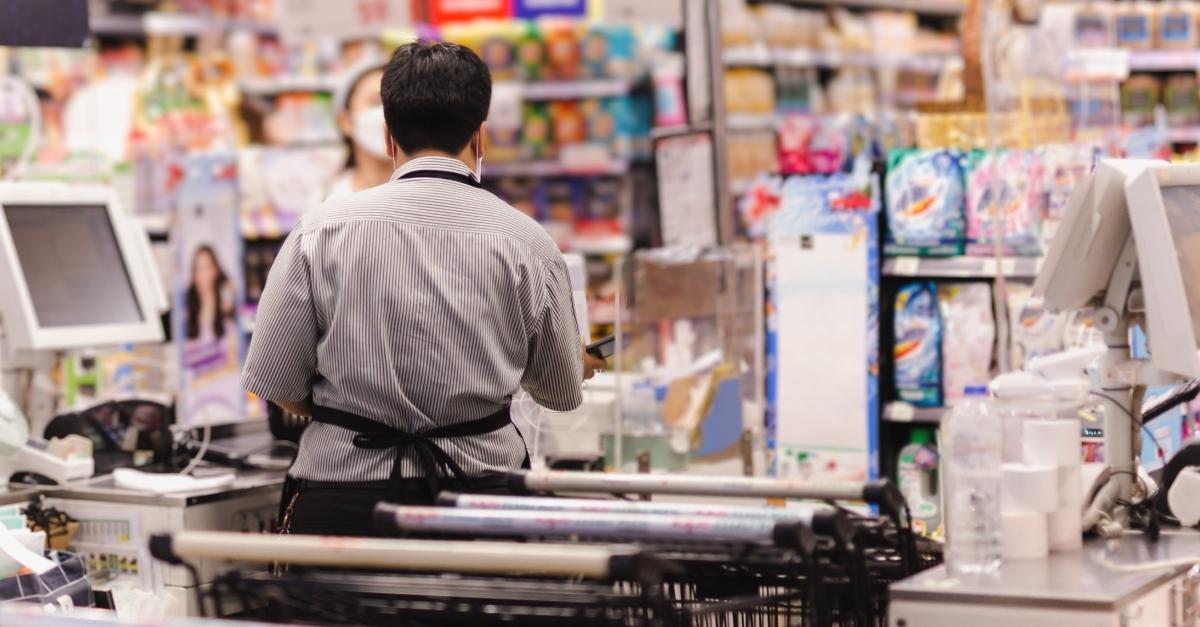 Lady at the POS punching the goods at the barcode