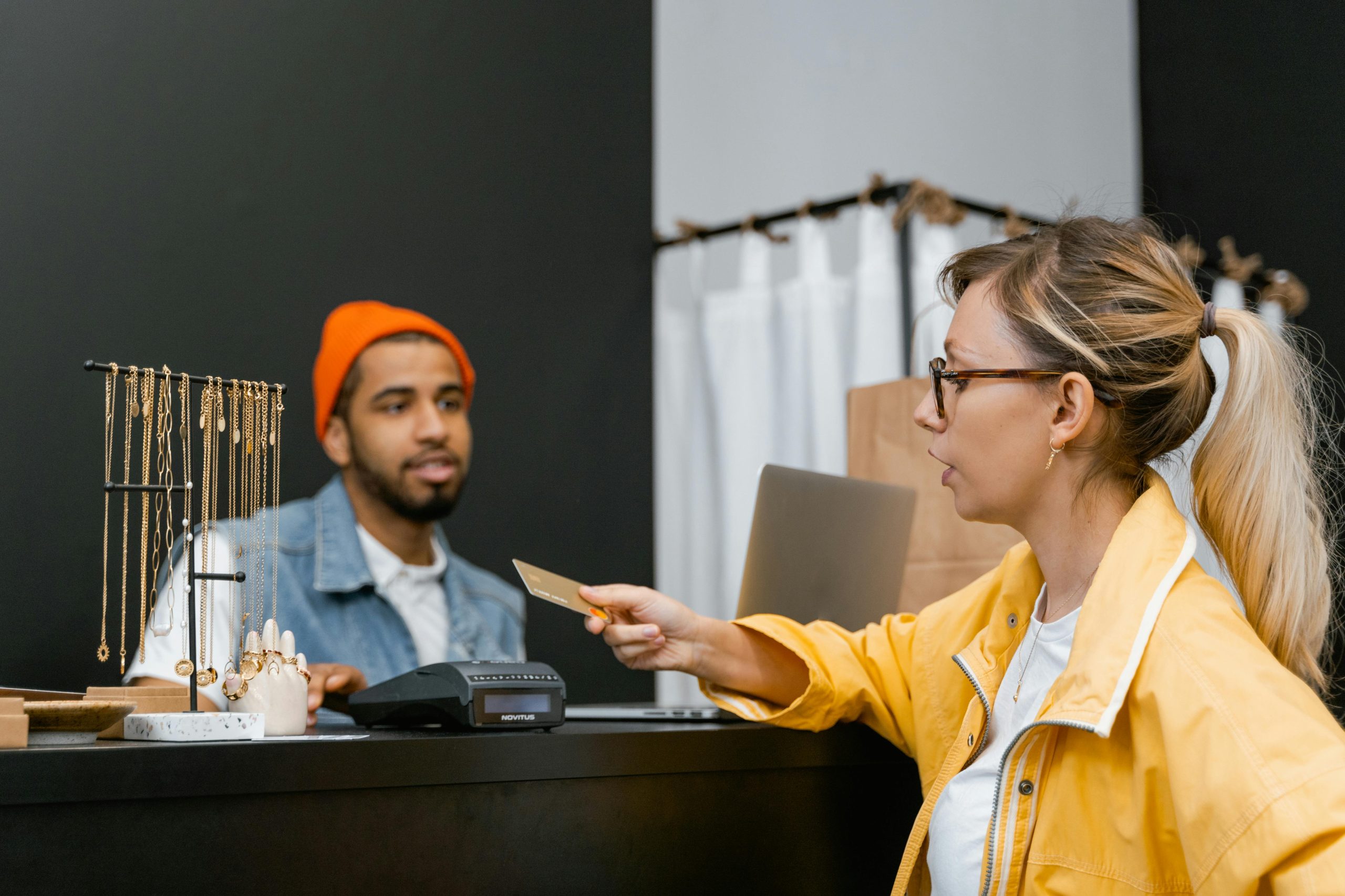A Woman Using a Credit Card in a Clothing Store A Woman Using a Credit Card in a Clothing Store
